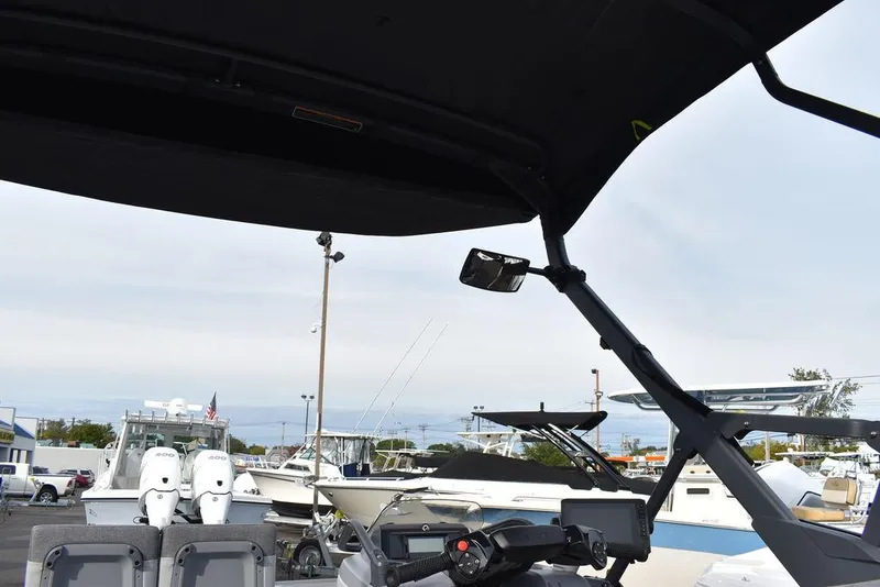 Slide: The Image of 2023 Sea-Doo Switch® Cruise 18-230 hp boat interior with canopy and control panel. - 34