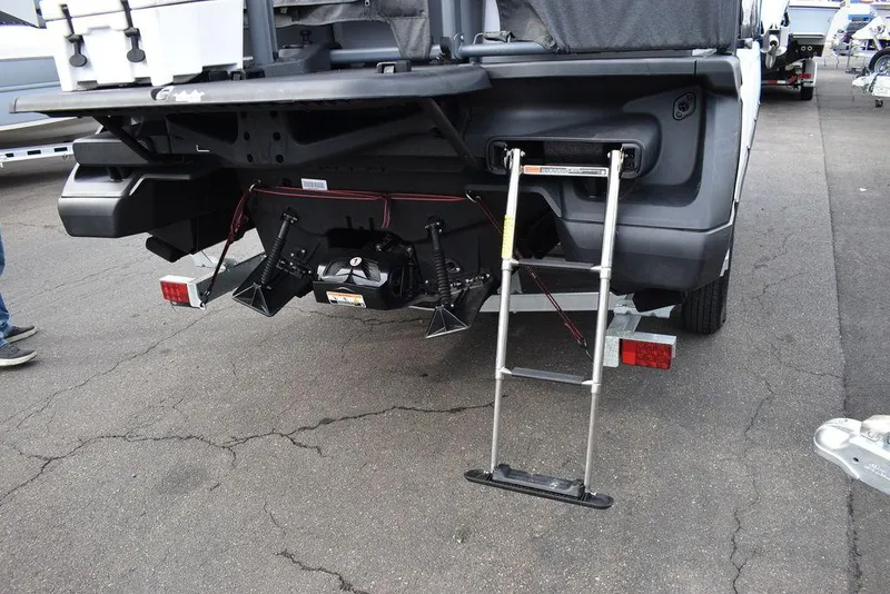 Slide: The Image of 2023 Sea-Doo Switch® Cruise 18-230 hp rear view with ladder and trailer. - 9