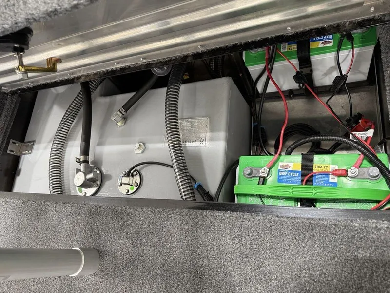 Slide: The Image of 2024 Tracker Pro Team™ 195 TXW Tournament Edition boat battery compartment with wiring and components. - 18