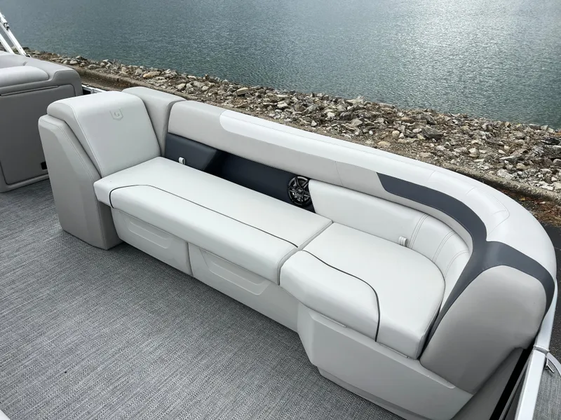 Slide: The Image of 2025 Godfrey Sweetwater 2286 C Special Edition boat seating by the water. - 10