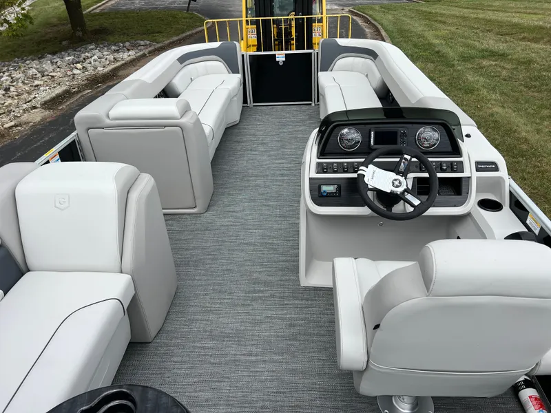 Slide: The Image of 2025 Godfrey Sweetwater 2286 C Special Edition pontoon boat interior with plush seating and modern helm. - 20