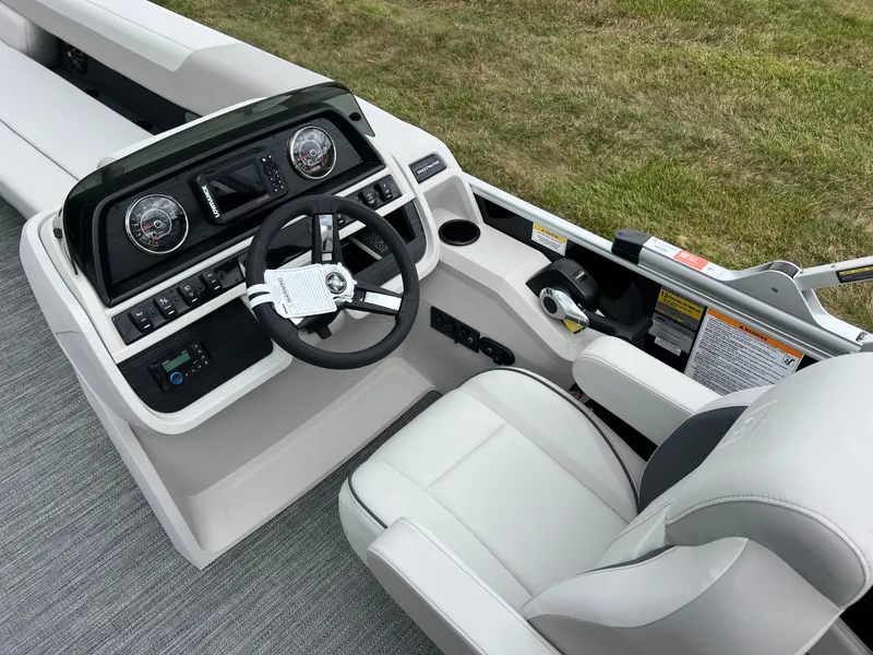 Slide: The Image of 2025 Godfrey Sweetwater 2286 C Special Edition boat cockpit with modern controls and seating. - 21