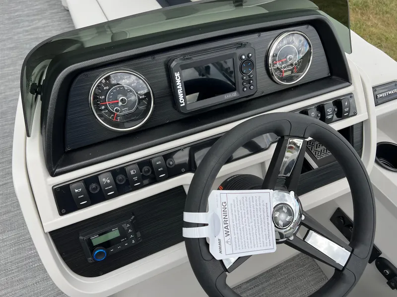 Slide: The Image of 2025 Godfrey Sweetwater 2286 C dashboard with steering wheel and control panel. - 22