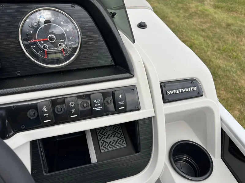 Slide: The Image of Dashboard of 2025 Godfrey Sweetwater 2286 C Special Edition boat with controls and cup holder. - 23