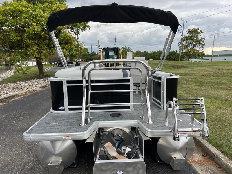 Slide: The Image of 2025 Godfrey Sweetwater 2286 C Special Edition pontoon boat, rear view with canopy and ladder. - 5