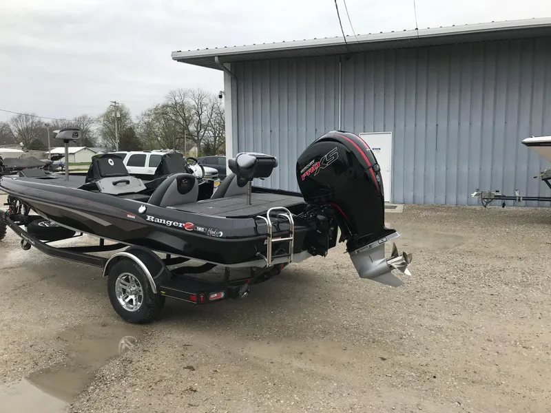 Slide: The Image of 2025 Ranger Z185 boat on trailer, parked outdoors near a building. - 2
