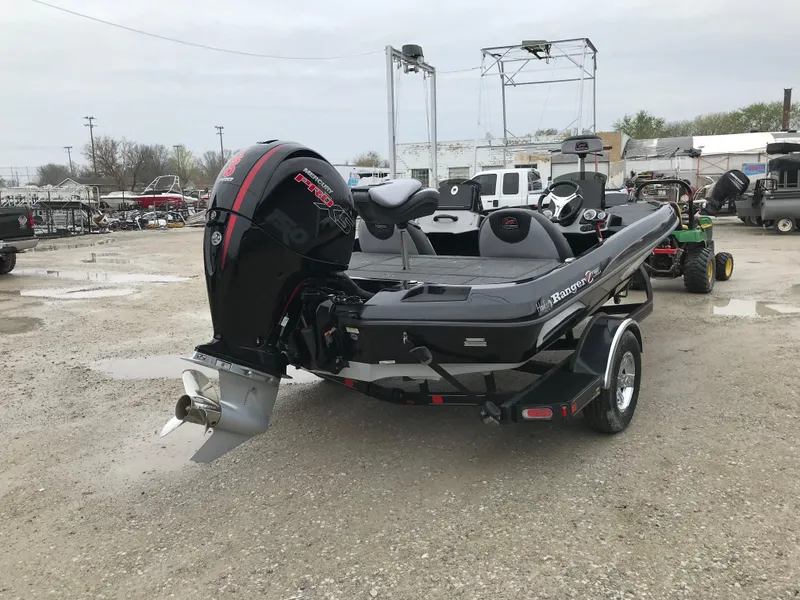 Slide: The Image of 2025 Ranger Z185 boat with outboard motor in a parking lot. - 4