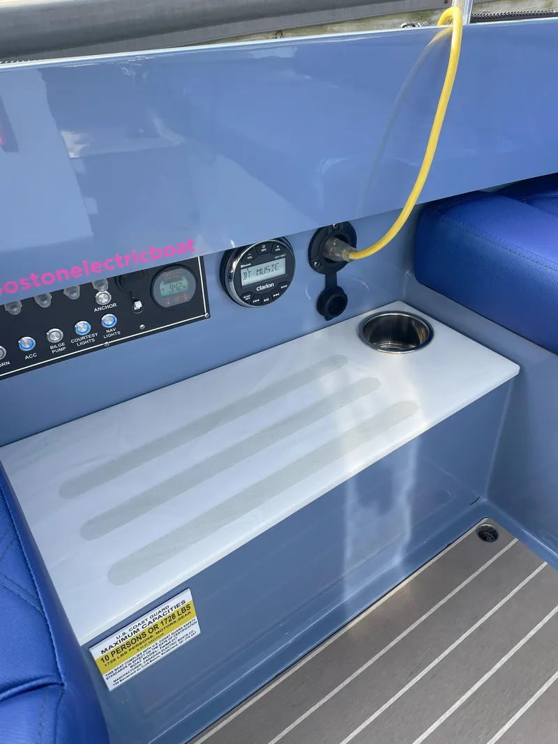 Slide: The Image of 2024 Vision Marine Technologies Fantail 217 boat dashboard with controls and seating. - 11