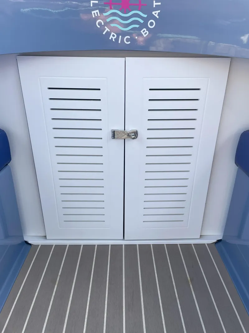 Slide: The Image of 2024 Vision Marine Technologies Fantail 217 boat interior with white louvered doors. - 12