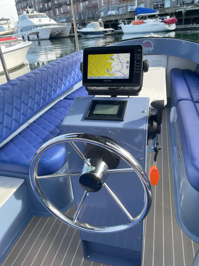 Slide: The Image of 2024 Vision Marine Technologies Fantail 217 boat interior with steering wheel and navigation system. - 4