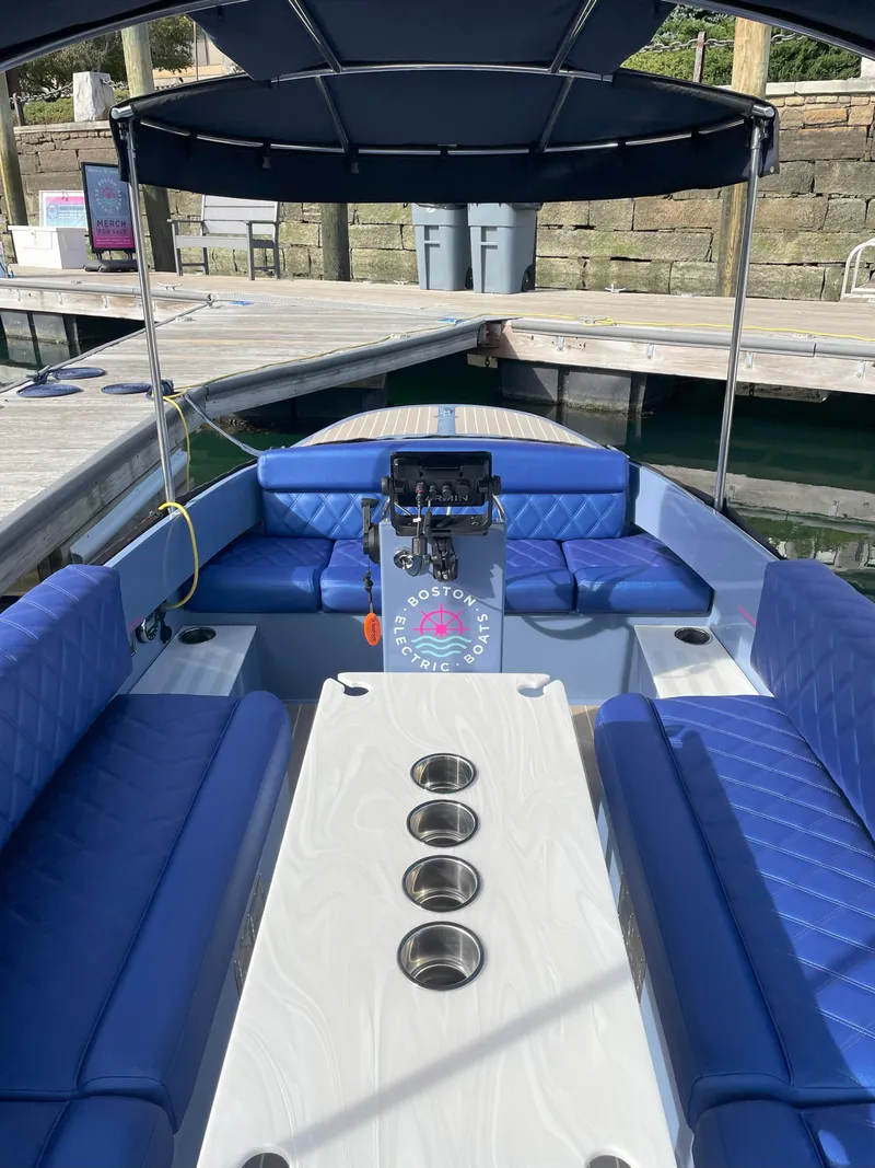 Slide: The Image of 2024 Vision Marine Technologies Fantail 217 boat with blue seating and canopy at dock. - 9