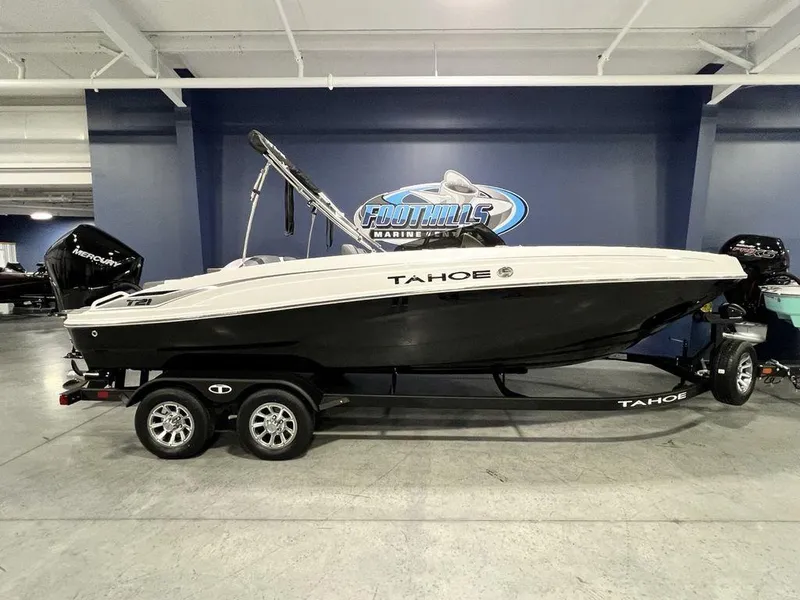 The Image of 2025 Tahoe T21 boat on trailer in showroom, side view. - 1
