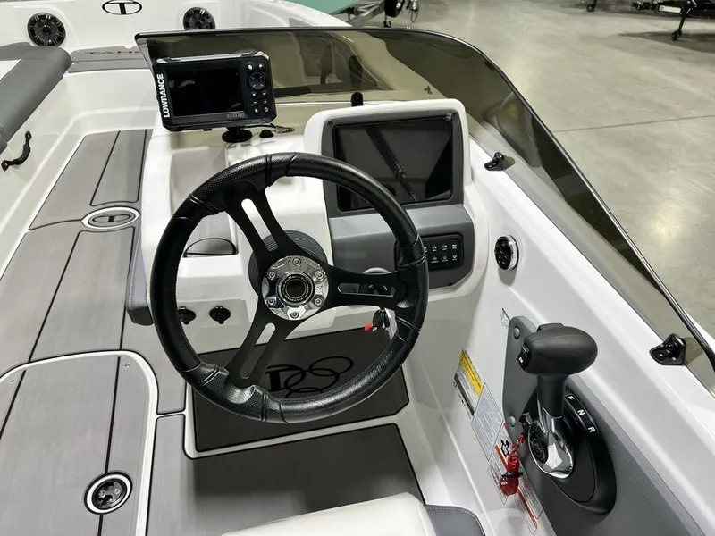 Slide: The Image of 2025 Tahoe T21 boat cockpit with steering wheel, control panel, and navigation display. - 12