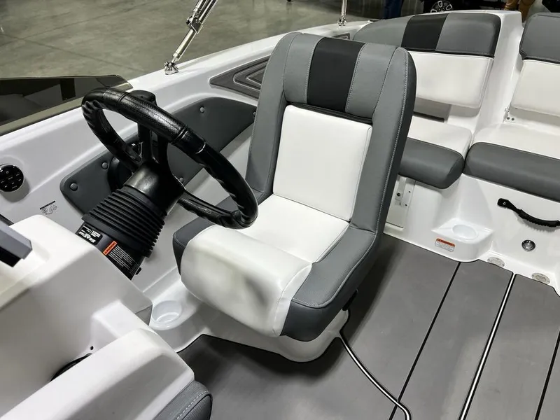 Slide: The Image of 2025 Tahoe T21 boat interior with steering wheel and cushioned seating. - 13