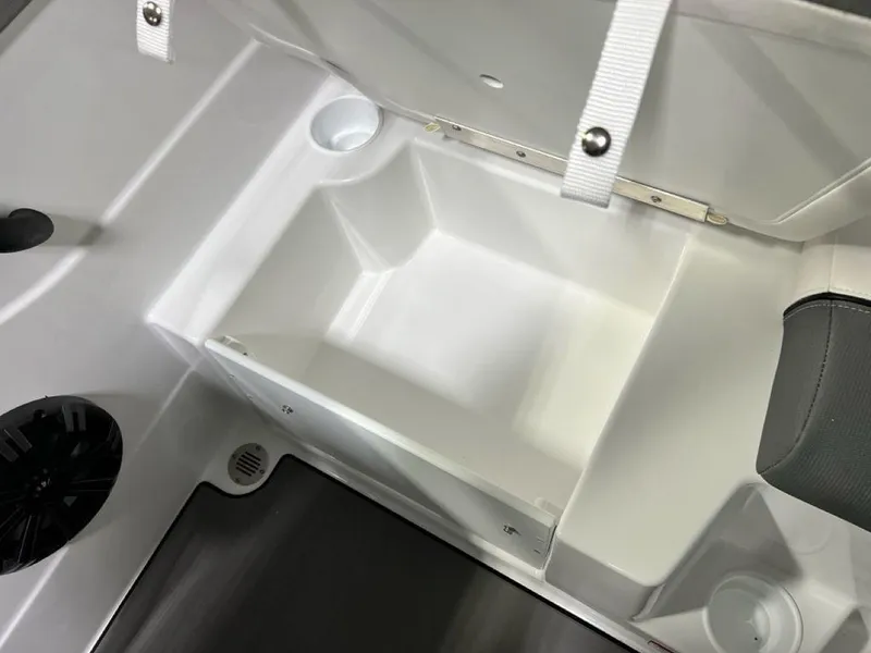 Slide: The Image of 2025 Tahoe T21 boat storage compartment with cup holders and secure straps. - 17