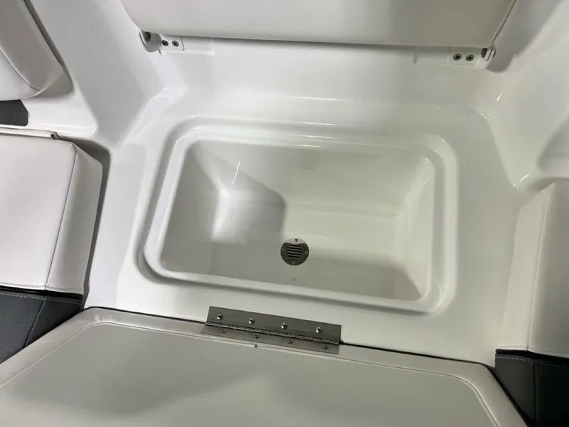 Slide: The Image of 2025 Tahoe T21 boat storage compartment with drain, featuring sleek white interior design. - 18