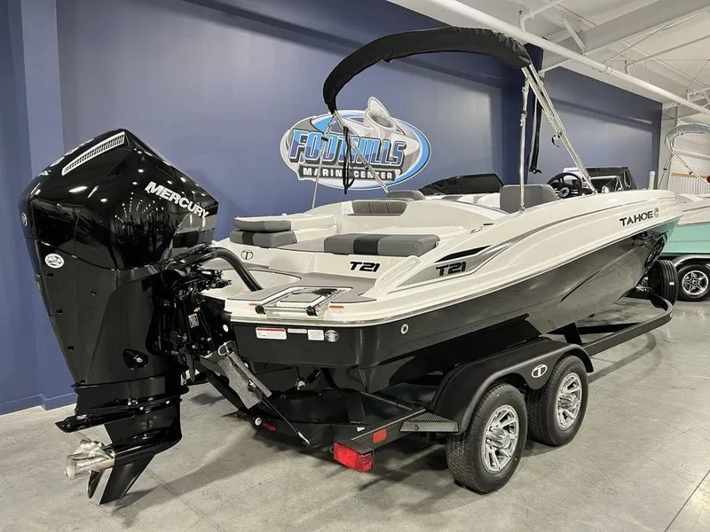 Slide: The Image of 2025 Tahoe T21 boat with Mercury engine on trailer in showroom. - 2