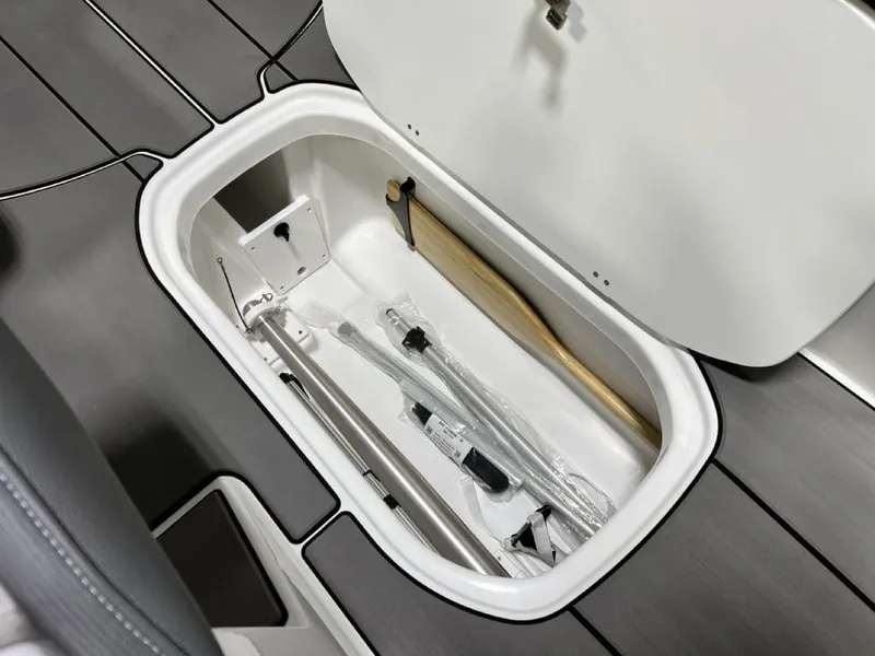 Slide: The Image of Storage compartment in 2025 Tahoe T21 boat, containing various equipment and accessories. - 8