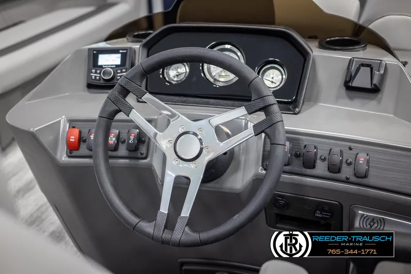 Slide: The Image of 2025 Bennington 23 SSRSE boat dashboard with steering wheel and control panel. - 25