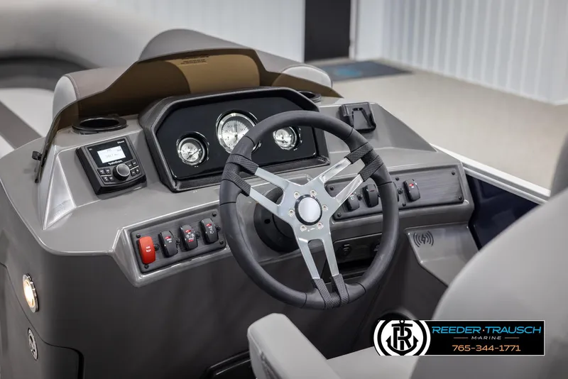 Slide: The Image of 2025 Bennington 23 SSRSE boat dashboard with steering wheel and control panel. - 26
