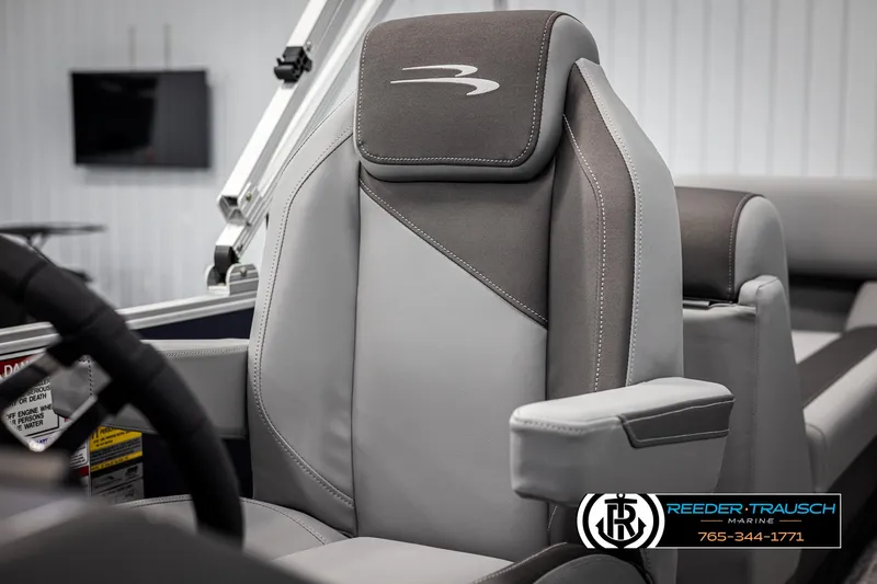 Slide: The Image of 2025 Bennington 23 SSRSE boat seat with sleek gray upholstery and armrest. - 33