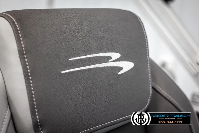 Slide: The Image of 2025 Bennington 23 SSRSE boat seat with logo, featuring sleek gray upholstery. - 38
