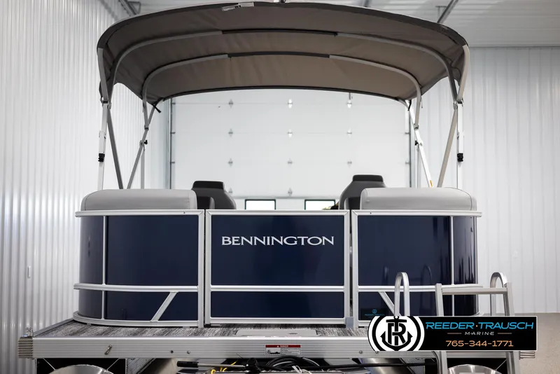 Slide: The Image of 2025 Bennington 23 SSRSE pontoon boat in a showroom, featuring a sleek design and canopy. - 7