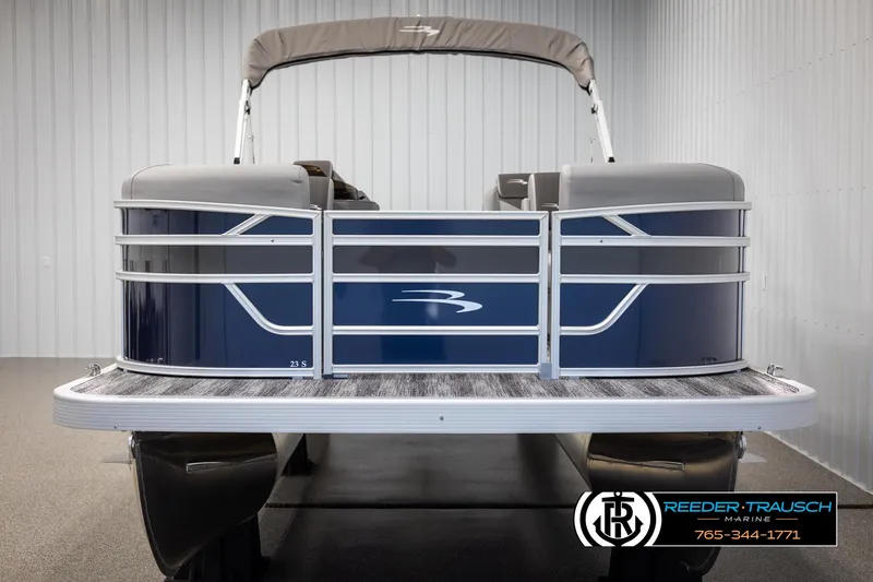 Slide: The Image of 2025 Bennington 23 SSRSE pontoon boat in showroom, featuring sleek blue design and modern amenities. - 8