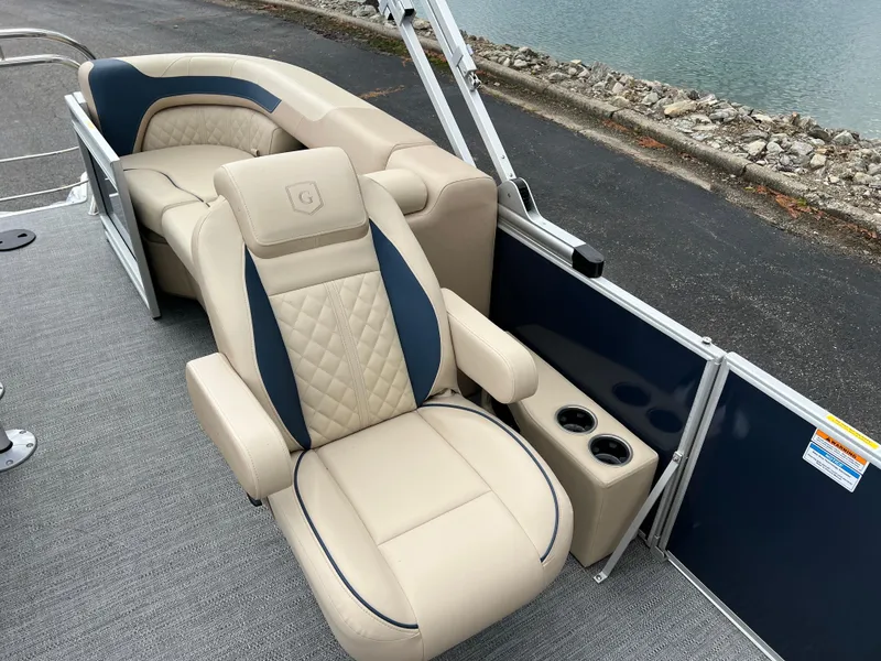 Slide: The Image of Luxurious seating on 2025 Godfrey SWEETWATER 2286 SB pontoon boat, featuring beige and blue upholstery. - 17