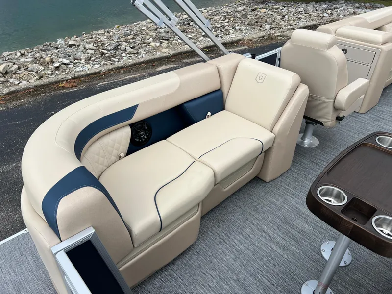 Slide: The Image of 2025 Godfrey SWEETWATER 2286 SB pontoon boat interior with beige seating and cup holders. - 22