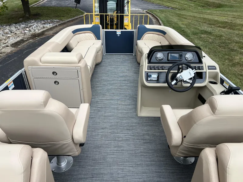 Slide: The Image of 2025 Godfrey SWEETWATER 2286 SB pontoon boat interior with beige seating and modern dashboard. - 24