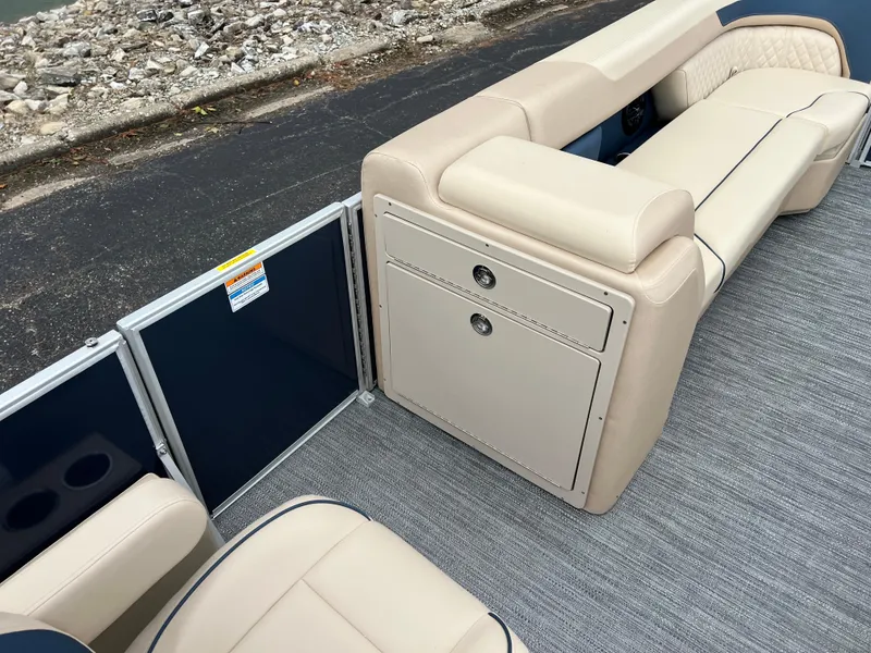 Slide: The Image of 2025 Godfrey SWEETWATER 2286 SB boat interior with beige seating and storage compartments. - 25