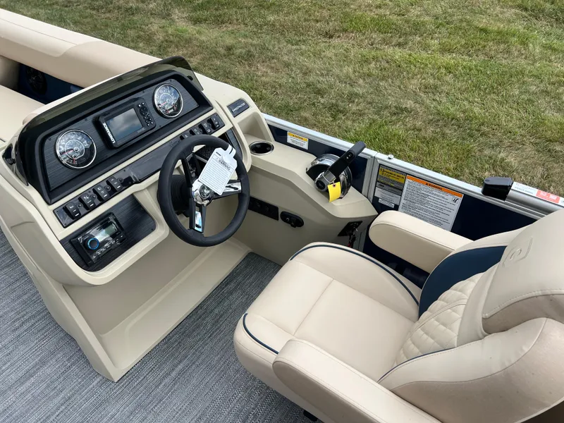 Slide: The Image of 2025 Godfrey SWEETWATER 2286 SB boat interior with steering wheel and control panel. - 27