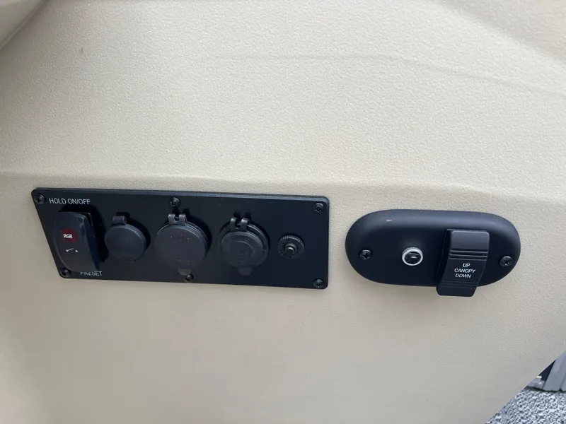 Slide: The Image of Control panel on 2025 Godfrey SWEETWATER 2286 SB boat, featuring various switches and outlets. - 30