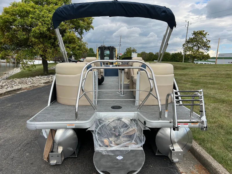 Slide: The Image of 2025 Godfrey SWEETWATER 2286 SB pontoon boat with seating, docked on a paved area. - 6