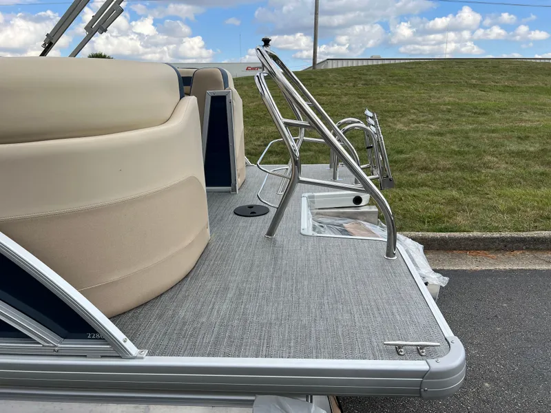 Slide: The Image of 2025 Godfrey SWEETWATER 2286 SB pontoon boat with seating and ladder, parked on grass. - 8