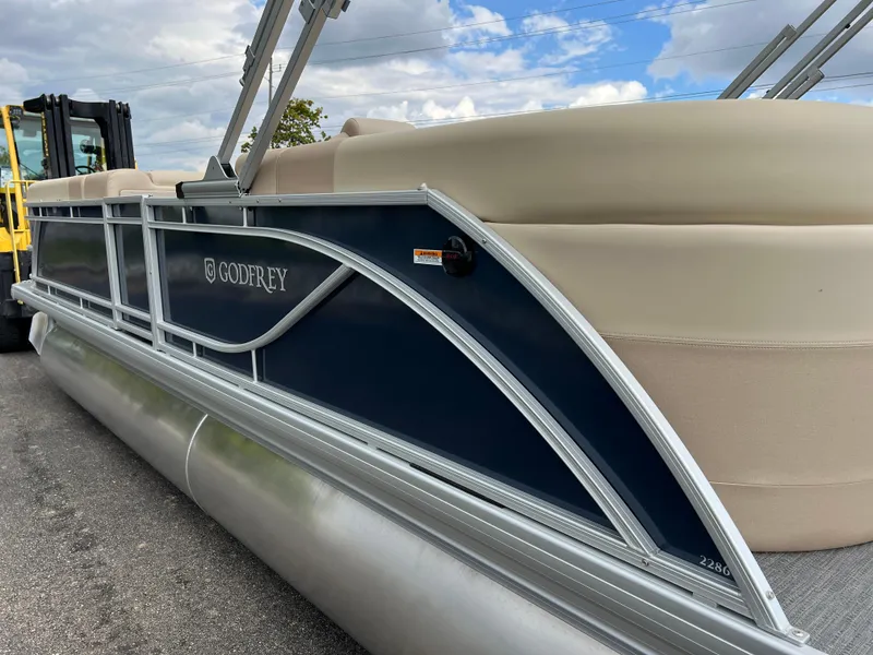 Slide: The Image of 2025 Godfrey SWEETWATER 2286 SB pontoon boat with sleek design and beige seating. - 9