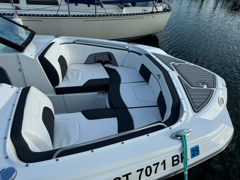 Slide: The Image of 2022 Monterey M-45 boat with sleek seating, docked on calm water. - 13