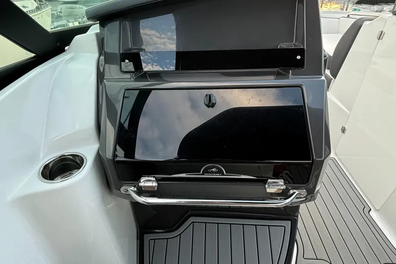 Slide: The Image of 2022 Monterey M-45 boat dashboard with sleek black panel and modern design. - 26