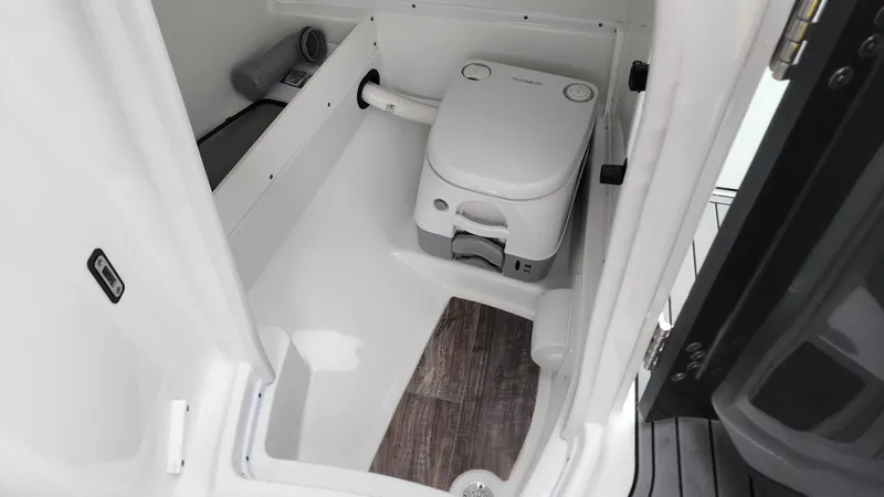 Slide: The Image of 2022 Monterey M-45 boat bathroom with compact toilet and wood-style flooring. - 40