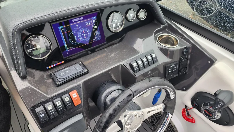 Slide: The Image of 2022 Monterey M-45 boat dashboard with steering wheel, gauges, and control panel. - 41