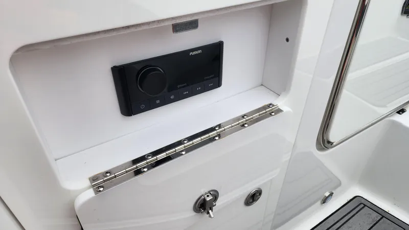 Slide: The Image of Monterey M-45 2022 boat control panel with sleek design and secure storage. - 48