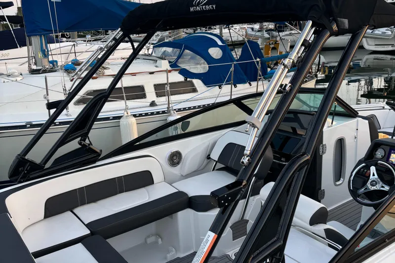 Slide: The Image of 2022 Monterey M-45 boat interior with sleek seating and modern design at a marina. - 5