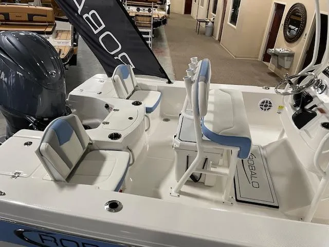 Slide: The Image of 2025 Robalo 206 Cayman boat interior with seating and steering console. - 6