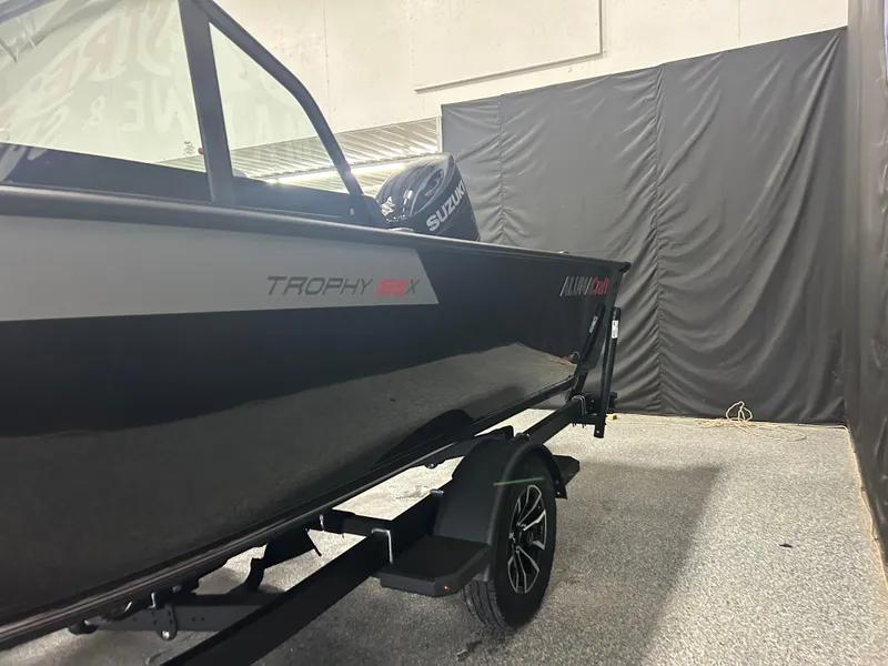 Slide: The Image of 2025 Alumacraft Trophy 185X Sport boat on display in showroom. - 3