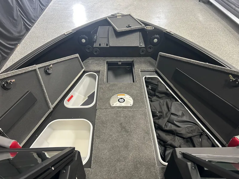 Slide: The Image of 2025 Alumacraft Trophy 185X Sport boat interior with open storage compartments. - 8