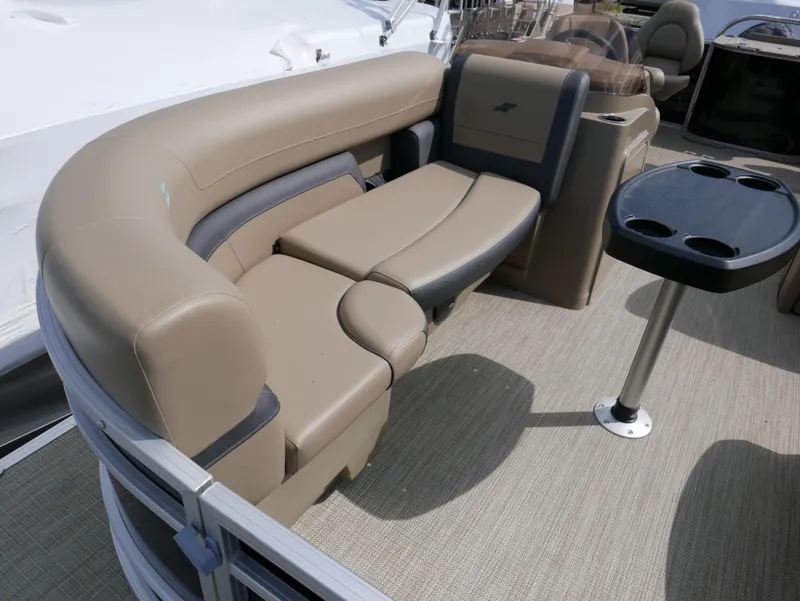 Slide: The Image of Starcraft EX Fish 20 FD 2025 boat interior with beige seating and cupholder table. - 10