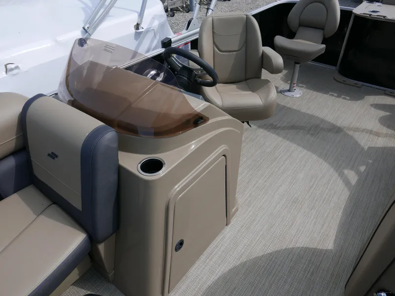 Slide: The Image of 2025 Starcraft EX Fish 20 FD boat interior with beige seating and steering console. - 14