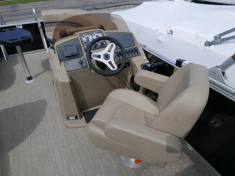 Slide: The Image of 2025 Starcraft EX Fish 20 FD boat helm with beige captain's chair and steering wheel. - 15