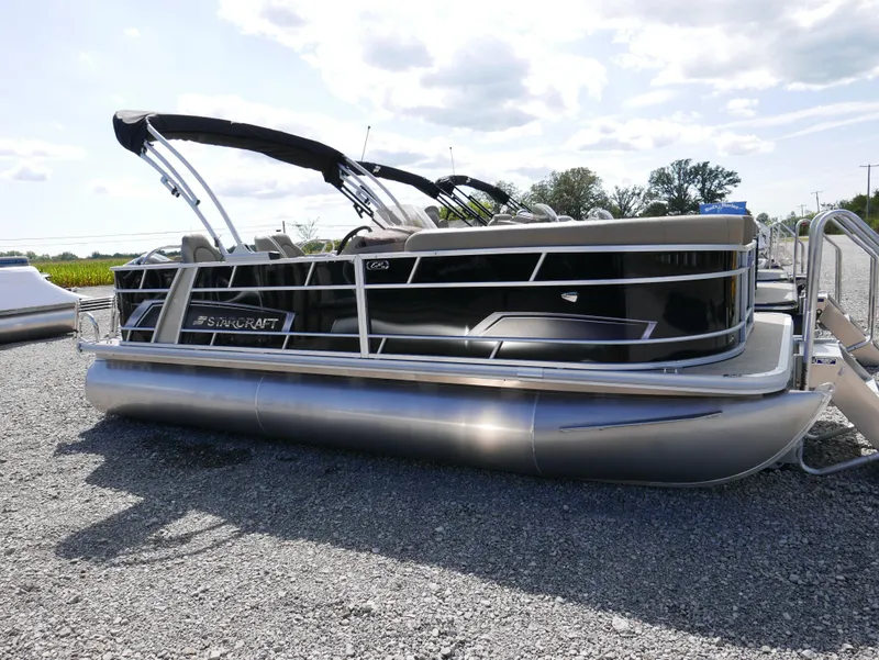 Slide: The Image of 2025 Starcraft EX Fish 20 FD pontoon boat on gravel lot under cloudy sky. - 24